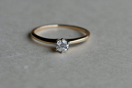 A classic old cut diamond solitaire ring set in 14K yellow gold. This ring dates to the early 20th century has a slender shank and a six-pronged head. The ring holds a .26 carat Old European Cut diamond, just a hair over 1/4 carat and lively as can be!