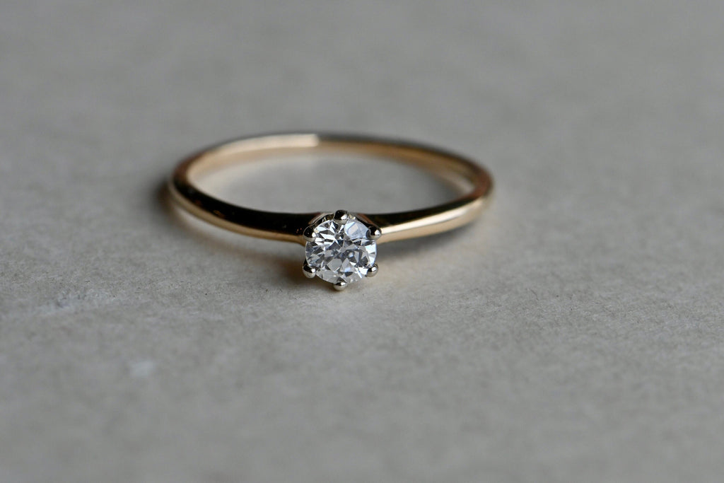 A classic old cut diamond solitaire ring set in 14K yellow gold. This ring dates to the early 20th century has a slender shank and a six-pronged head. The ring holds a .26 carat Old European Cut diamond, just a hair over 1/4 carat and lively as can be!