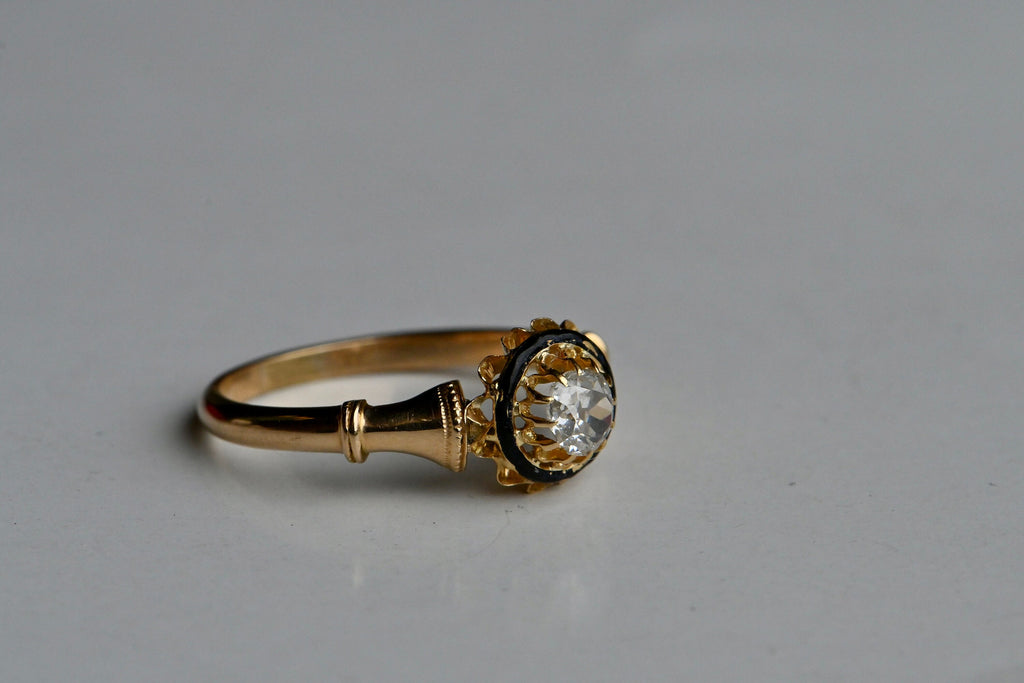 An 18K Victorian solitaire engagement ring with tiers of details and a VS/E-F Old Mine Cut diamond. Victorian engagement rings all share some common attributes: Old cut diamonds, usually set as singletons (sometimes as trios); multi-prong settings in high-karat yellow gold; buttercup heads and trumpet-style shoulders